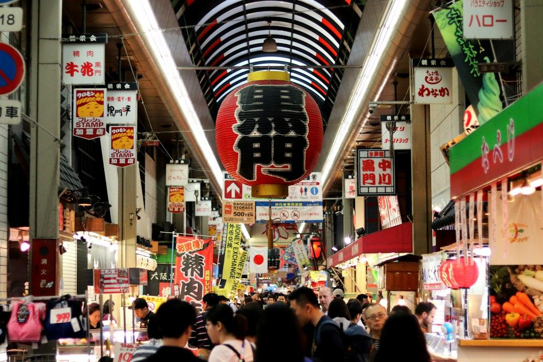 Shoppers walking through a covered market in Osaka