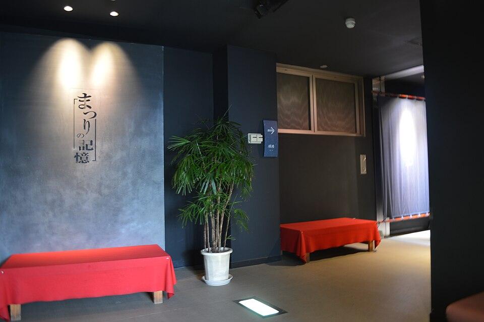 Interior seating area with red benches at Kawagoe Festival Museum